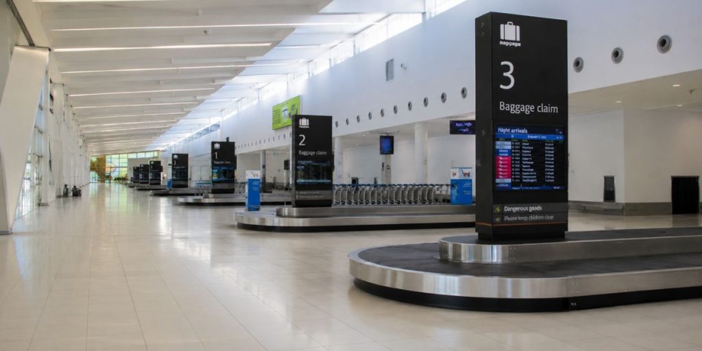 perth-airport-baggage-claim-terminal Modern airport baggage claim area with luggage carousels and arrival screens at Perth Airport
